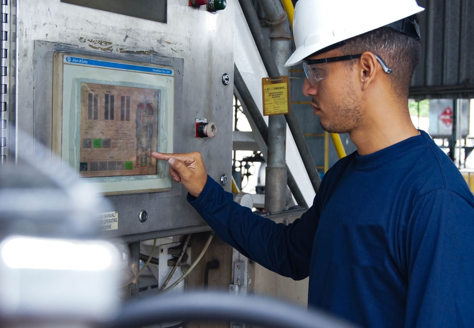 Engineer operating an Allen-Bradley HMI on a process line